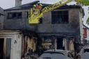 The charred wreck of a Wembley house after a lithium battery failed while it was charging