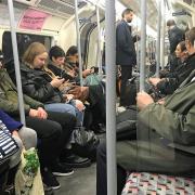 A man on the Underground wearing a protective facemask. Picture: PA