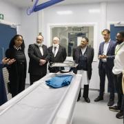 Council officials and faith leaders in the scanning room