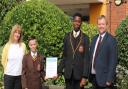 Michelle Roddy (left) with headteacher Chris McCormack and two students with the certificate from the Carnegie Centre of Excellence for Mental Health in Schools.