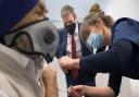 Labour leader Sir Keir Starmer watches as Dr Lizzie Goodman injects a patient with their first dose of the Pfizer-BioNTech Covid-19 vaccine.