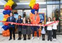 Team GB Olympian Toby Harries and store manager Giuseppe Daniello cut the ribbon at Aldi with children from North Beckton Primary School