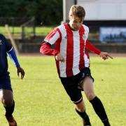 Fred Taylor of Clapton CFC evades a Kensington defender.