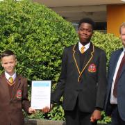 Michelle Roddy (left) with headteacher Chris McCormack and two students with the certificate from the Carnegie Centre of Excellence for Mental Health in Schools.