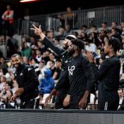 London Lions players celebrate from the sidelines during their win over Cheshire Phoenix