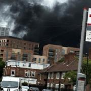 A picture taken near the fire in Canning Town shows thick black smoke rising from the scene