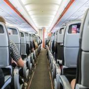 Holidaymakers and Jet2 staff can be seen staring in shock at the passenger's actions just inches from flight attendants' faces